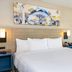 Comfort Inn Kingston - Highway 401 guest room with king bed, sofa, and bedside lamps in Kingston