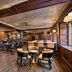 Omni Parker House Boston wood-paneled lounge with tables, chairs and warm vintage interior