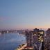 Millennium Hilton New York One UN Plaza with Manhattan skyline and East River at dusk
