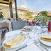 Residenza Paolo VI Rome terrace dining by pool with St. Peter's dome view