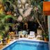 Casita de Maya Boutique Hotel in Cozumel courtyard pool surrounded by tropical plants and lounge chairs