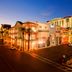 The Orleans Hotel & Casino in Las Vegas at dusk, with illuminated exterior and street view