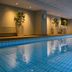 Indoor pool at Original Sokos Hotel Lappee in Lappeenranta with calm water and lounge seating
