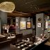 Grand Bohemian Lodge Greenville, Autograph Collection art gallery-style lobby with displays and pendant lighting