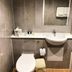 Britannia International Hotel London bathroom with sink, toilet, mirror and tiled walls