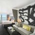 Hilton Motif Seattle guest room with king bed, sofa, and large waterfront view window