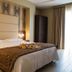 Hotel Pineta Palace Rome guest room with double bed, bedside lamps and balcony curtains