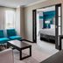 Four Points by Sheraton London guest room with seating area and adjoining bedroom