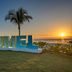 Fiesta Americana Cozumel sign on the waterfront at sunset with palm tree and ocean view