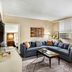Omni Parker House Boston suite with sectional sofa, coffee table, and city-view windows