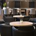 AC Hotels by Marriott La Rioja lounge with round tables, black chairs and a modern bar in Logroño