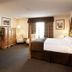 Petawawa River Inn & Suites room in Petawawa with king bed, sitting area and window view