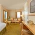 Orchard Garden Hotel San Francisco guest room with king bed, sitting area, and desk
