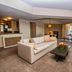 Millennium Hilton New York One UN Plaza suite with sofa, coffee table and city-view windows in New York