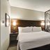 Best Western London Airport Inn & Suites guest room with king bed, sofa, and desk in London
