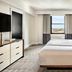 Omni Parker House Boston guest room with king bed, window city view, dresser and bedside lamps