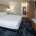 Fairfield by Marriott Inn & Suites Seattle Sea-Tac Airport guest room with king bed and seating area