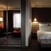 Pullman London St Pancras bedroom with king bed, tufted bench, and mirrored wardrobe in London