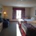 Petawawa River Inn & Suites in Petawawa guest room with two beds, window, and sitting area