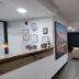 Sj Suites Hotel in San Juan lobby with front desk, seating area, and wall-mounted TV