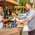 Guests toast drinks at the poolside bar at Hampton Inn & Suites by Hilton San Juan, San Juan.