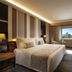 Kempinski Hotel Beijing Yansha Center guest room with king bed, desk, TV and city-view window in Beijing