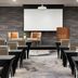 Crowne Plaza Toronto Airport By IHG meeting room with projector screen and rows of conference tables