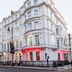 Park International Hotel in London, exterior of white corner building with red-lit entrance