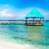 Grand Oasis Tulum in Akumal with overwater palapa cabanas and a turquoise ocean view