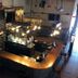 Petawawa River Inn & Suites bar area with curved counter, hanging lights, and chalkboard menu in Petawawa