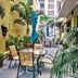 Canario Lagoon Hotel in San Juan courtyard with tables, chairs, umbrellas and tropical plants