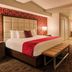Horseshoe Las Vegas guest room with king bed, bench, soaking tub, and modern carpeted interior