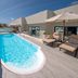 Grand Oasis Tulum in Akumal: rooftop pool with loungers, glass railing and ocean view