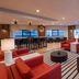The Westin Copley Place, Boston lobby lounge with red chairs, bar seating, and city windows