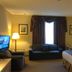 Petawawa River Inn & Suites in Petawawa guest room with bed, sofa, TV, and window seating area