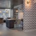 Tropica Beach Hotel in San Juan lounge with wicker chairs, bar seating, and large front windows