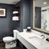 Waterfront Hotel Downtown Burlington bathroom with vanity, toilet, shower curtain and framed wall art