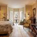 The College Club of Boston guest room with bed, seating area, fireplace and bay window in Boston
