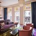 The Hotel Chelsea, New York guest room with stained-glass windows and French balcony doors