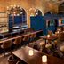 Delta Hotels by Marriott London Armouries lounge bar with high tables, stools and brick arches in London