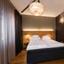 Original Sokos Hotel Lappee room with double bed, dark walls, and a hanging pendant light in Lappeenranta