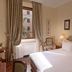 Residenza Paolo VI Rome guest room with king bed and large window with curtains