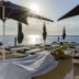 Coral Princess Hotel & Dive Resort in Cozumel with oceanfront loungers and umbrellas at sunset