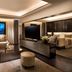 Kempinski Hotel Beijing Yansha Center suite with living area, TV, lounge chair and city view