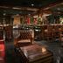 Prince Conti Hotel New Orleans lounge with leather chairs, bar, and dining tables