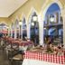 Crown Paradise Club Cancun restaurant with checkered tables and arched windows overlooking the sea