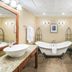Ramada by Wyndham Thunder Bay Airlane Hotel bathroom with clawfoot tub, double sinks and granite counters