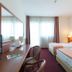 Airport Hotel Bergamo guest room in Bagnatica with two twin beds, desk, TV, and large window