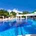 Grand Oasis Tulum in Akumal with a large blue lagoon-style pool and palm trees