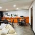 Sj Suites Hotel San Juan lobby lounge with seating, dining tables and a breakfast counter